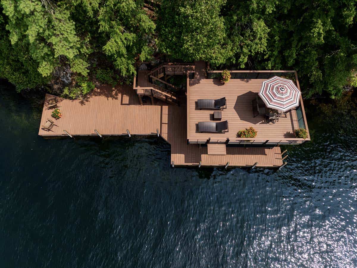 tudor style lake house with a deck