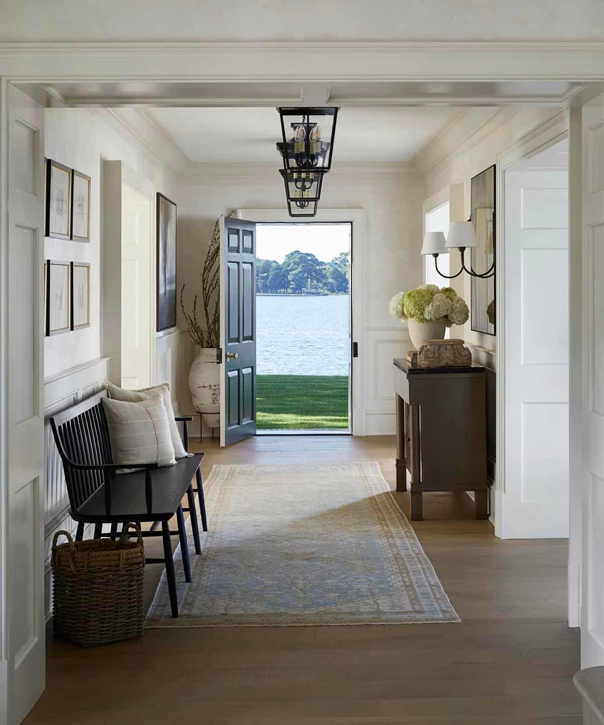 waterfront home entry with a bench and console table