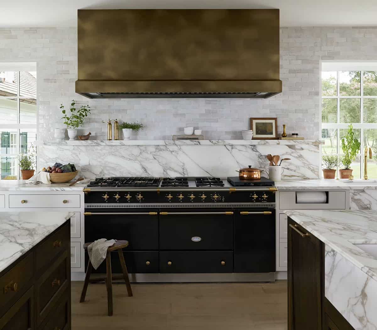 contemporary kitchen range wall with a large hood