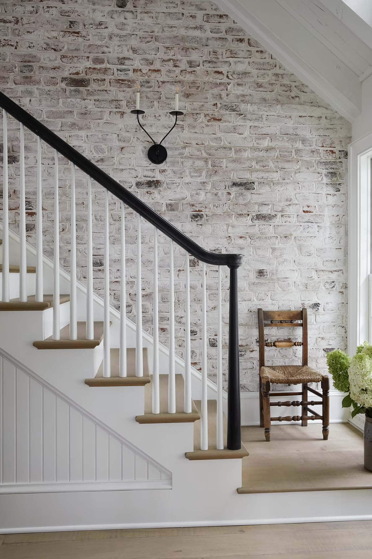 contemporary staircase with a brick wall
