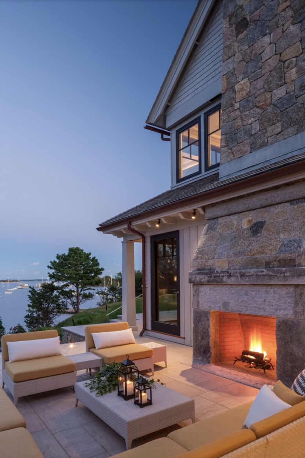 beach style house exterior patio with an outdoor fireplace