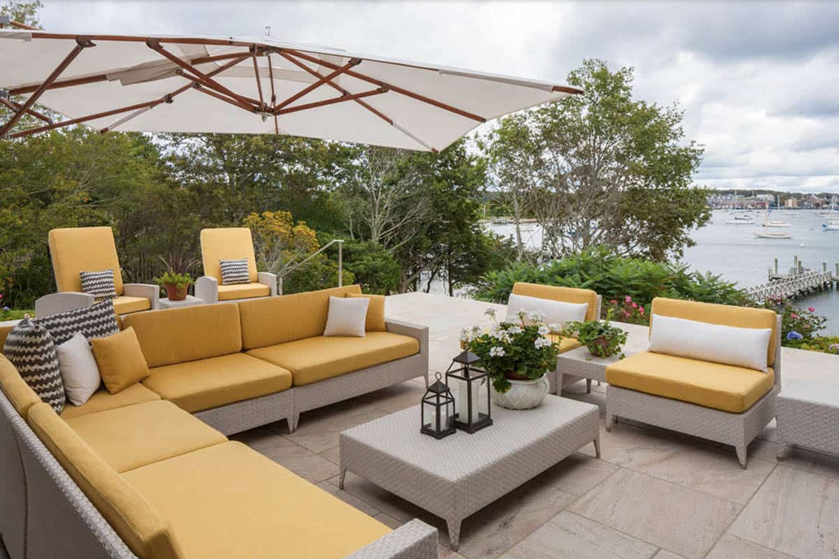 beach style patio with outdoor furniture and an umbrella