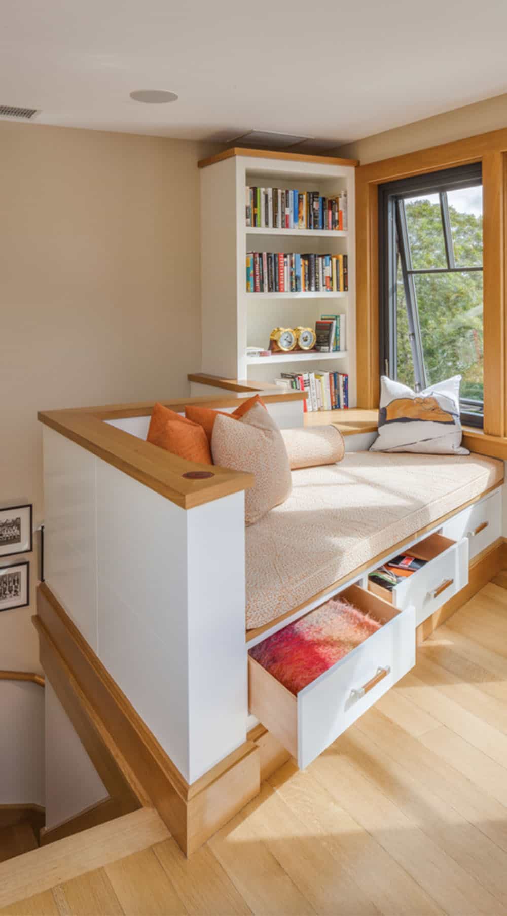 beach style family room with a build-in reading nook and storage drawers