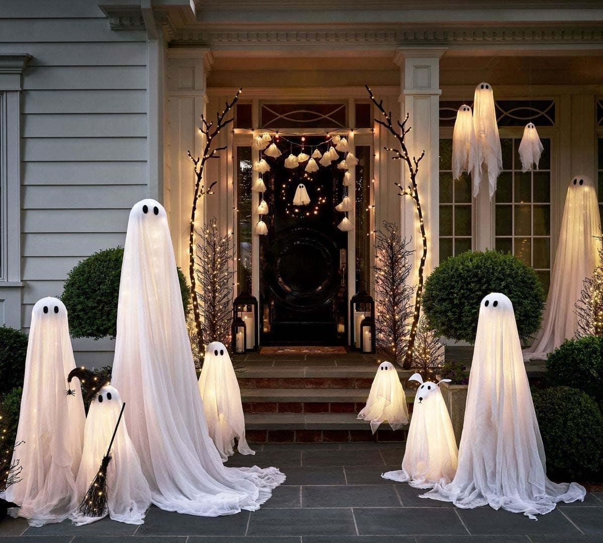 halloween decorated front porch with lighted ghosts