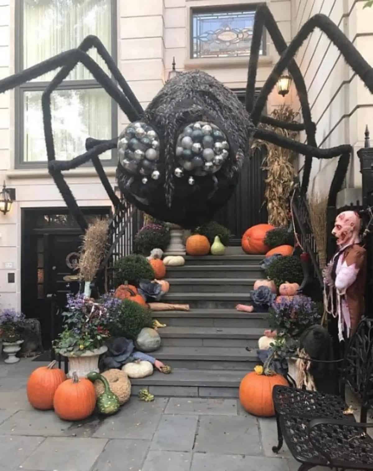 halloween decorated front porch steps with a big scary spider