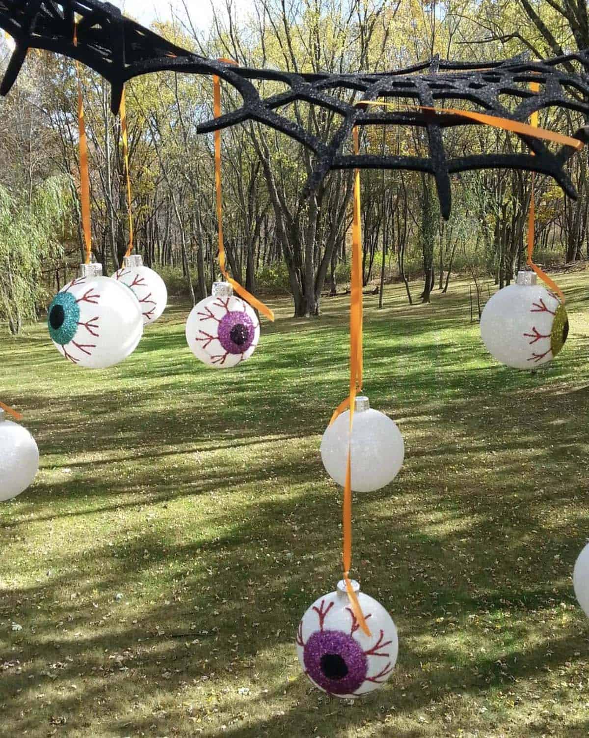spooky outdoor yard decor with giant hanging eyeballs
