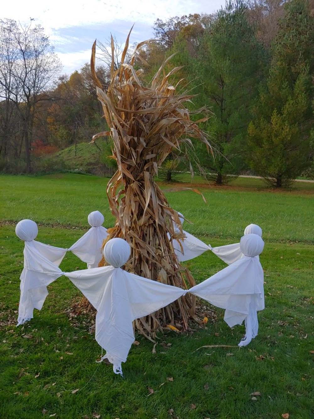 halloween decor on the yard with holding hands ghosts