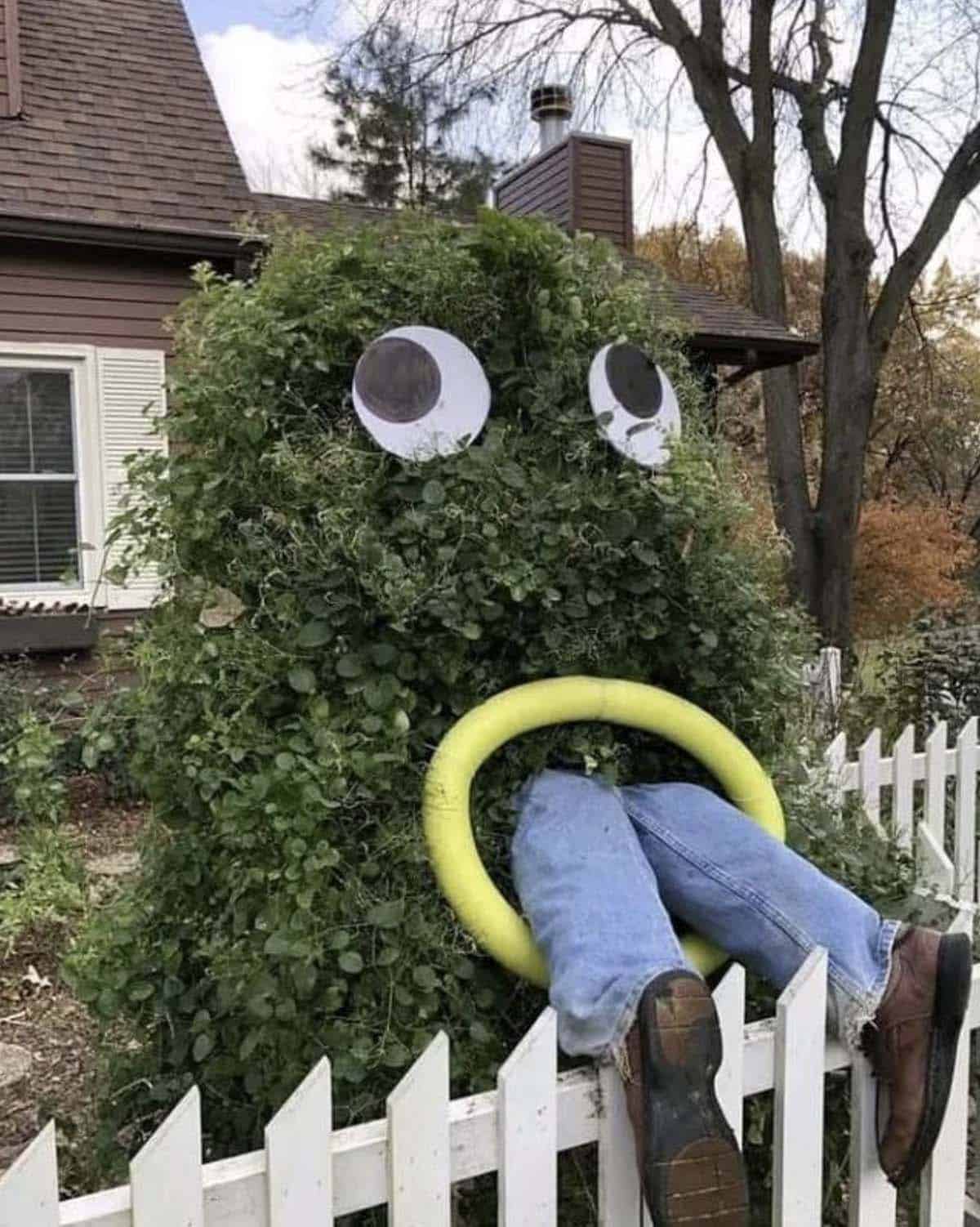 spooky halloween yard decor with googly eyes bush monster