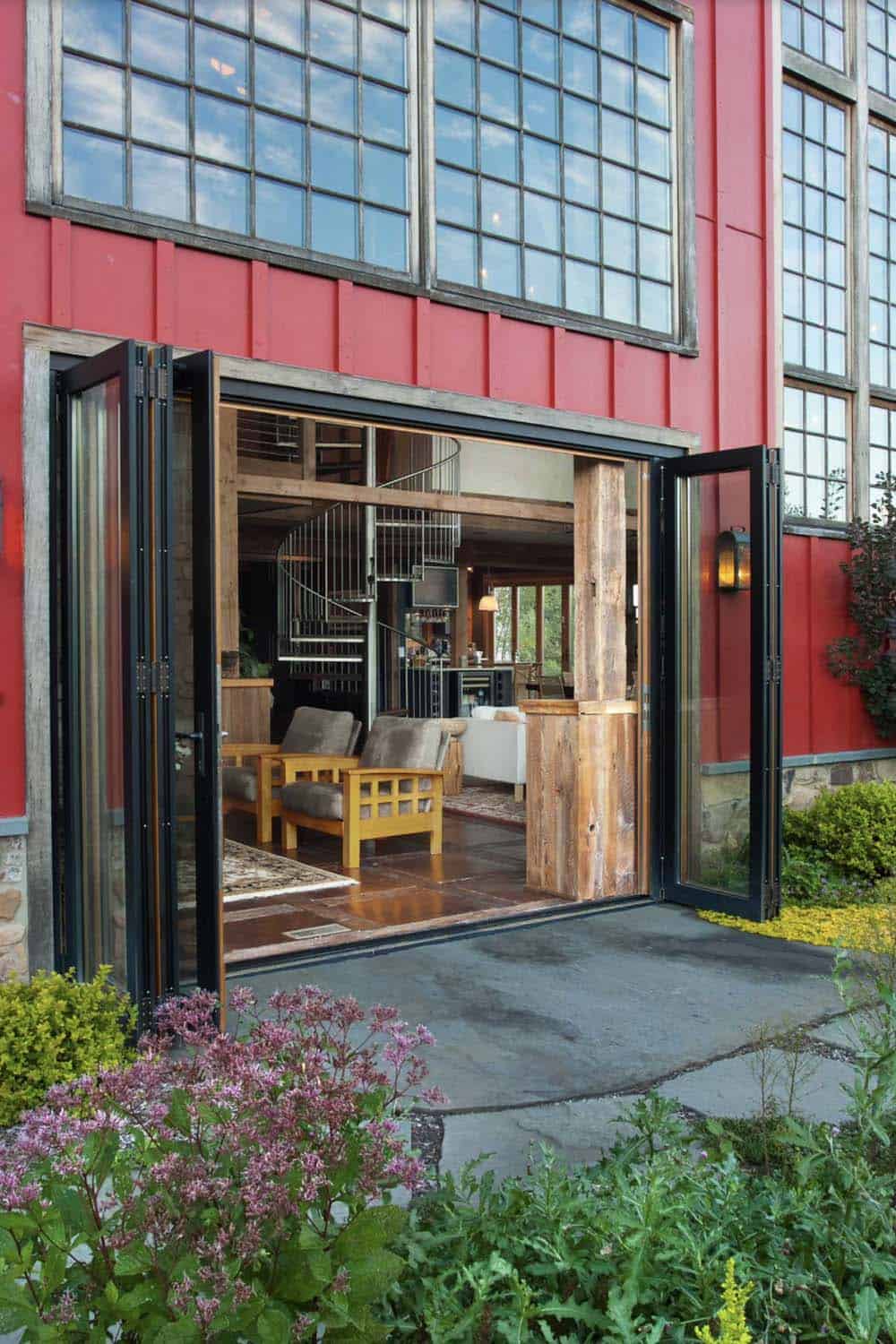 rustic modern barn house exterior with folding doors of glass