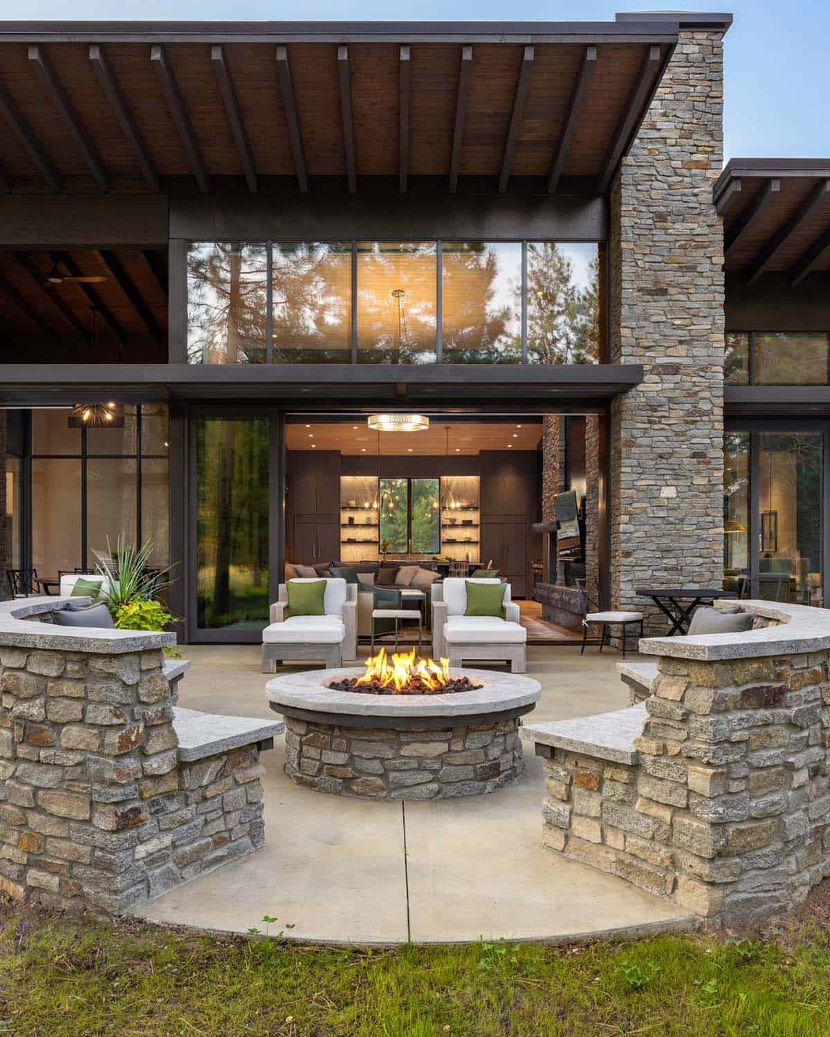 modern mountain home exterior patio with a fire pit
