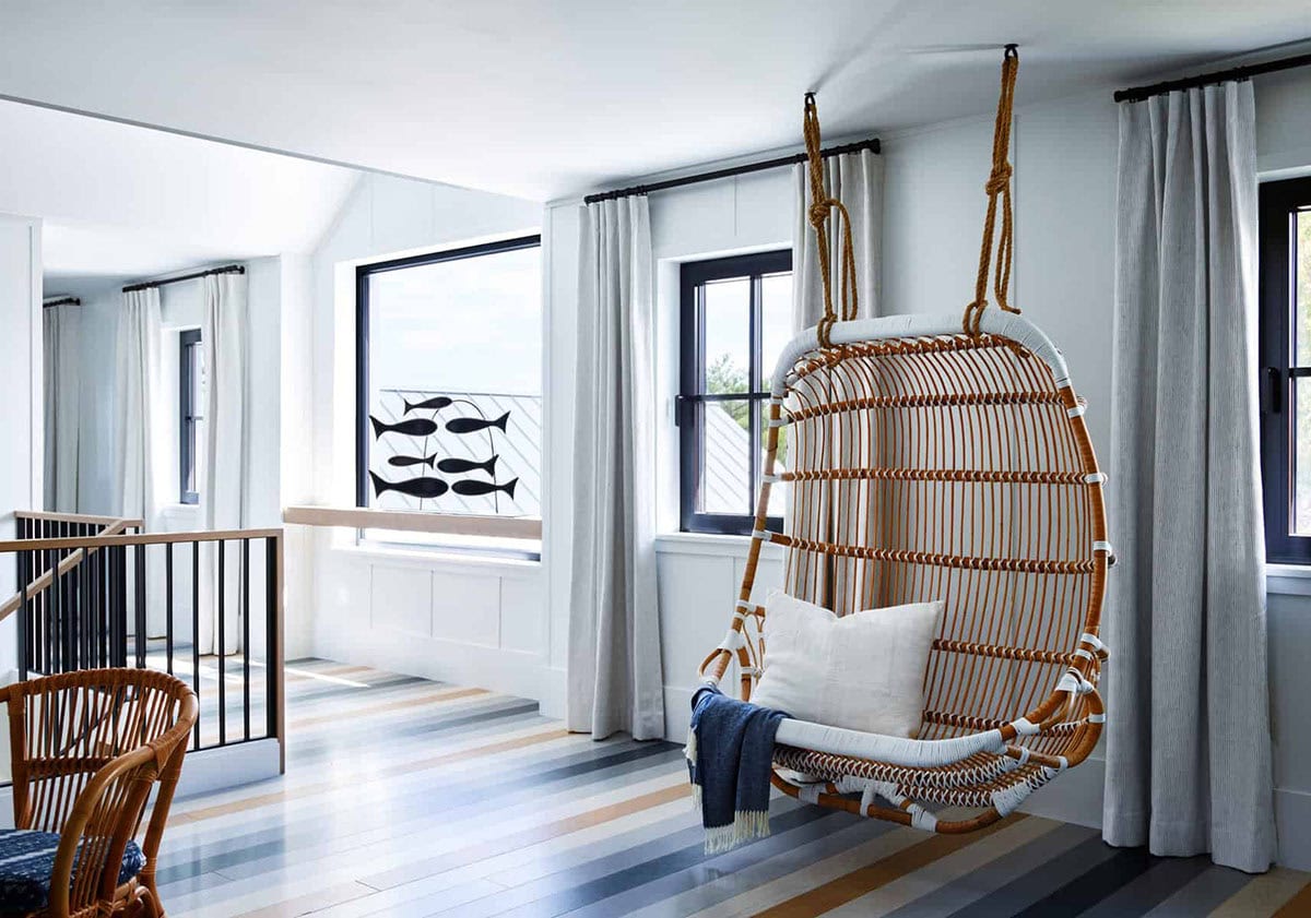 coastal modern farmhouse upstairs landing with a hanging chair