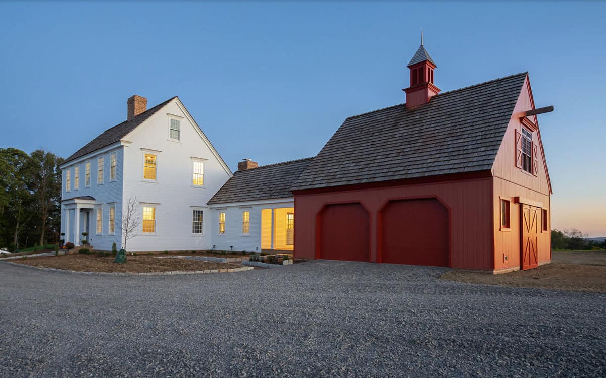colonial farmhouse exterior at dusk