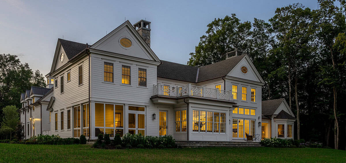 traditional style home exterior backyard view at dusk