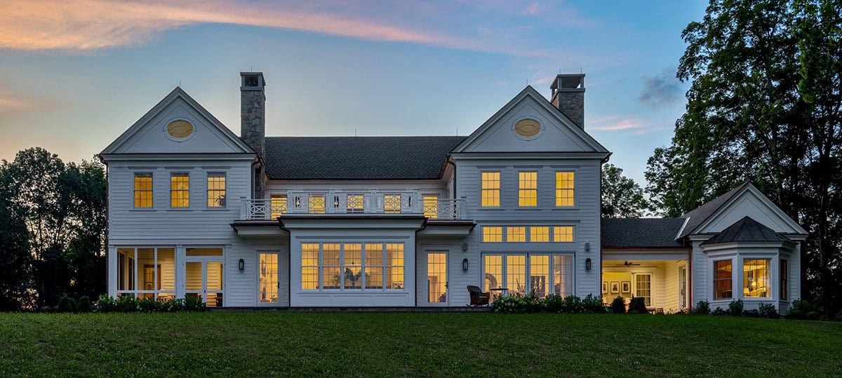 traditional style home exterior backyard view at dusk