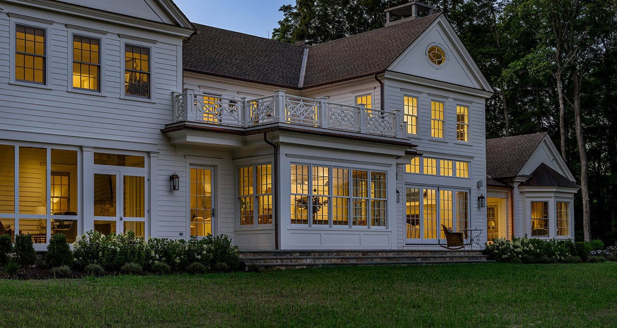 traditional style home exterior backyard view at dusk