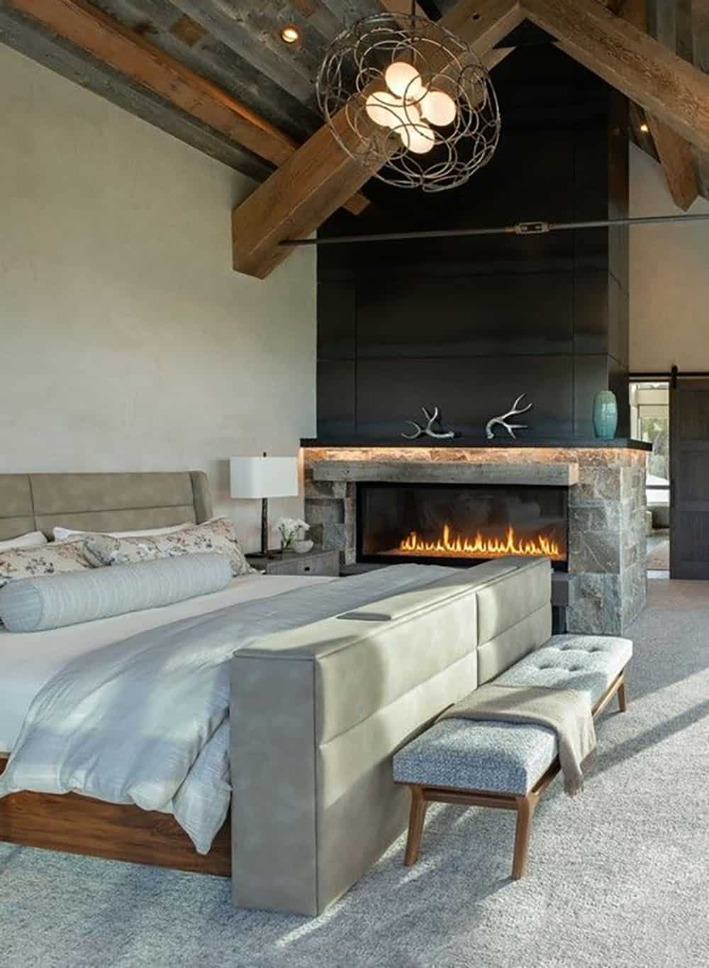 contemporary mountain house bedroom with a fireplace