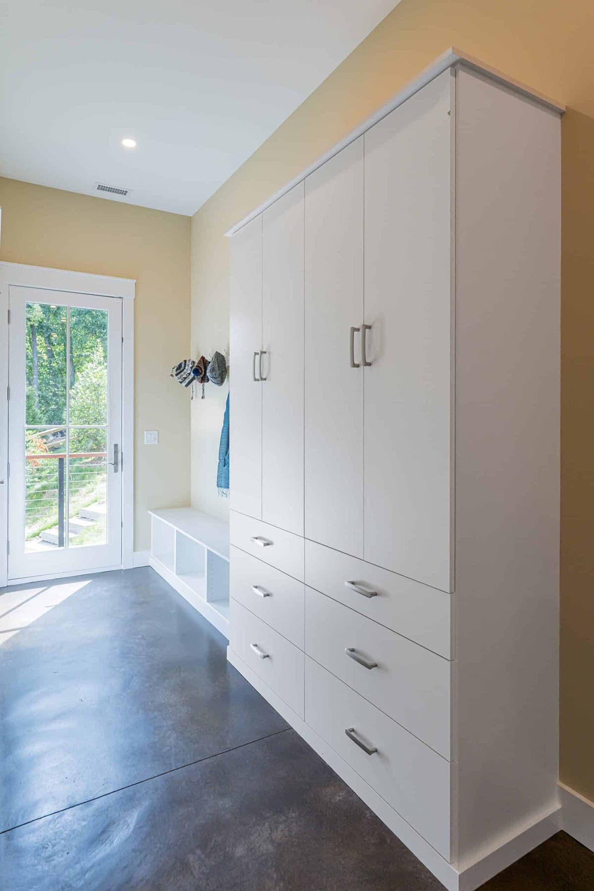 contemporary mudroom with built-in cabinet storage