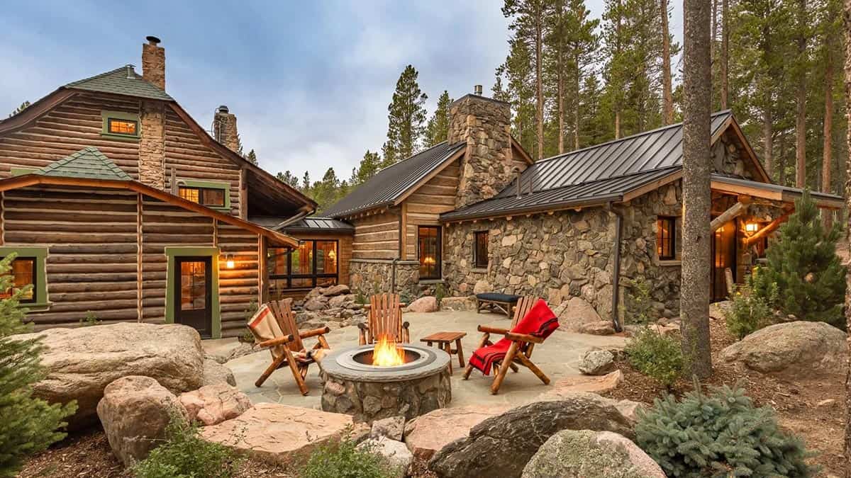 log cabin exterior with a patio and fire pit
