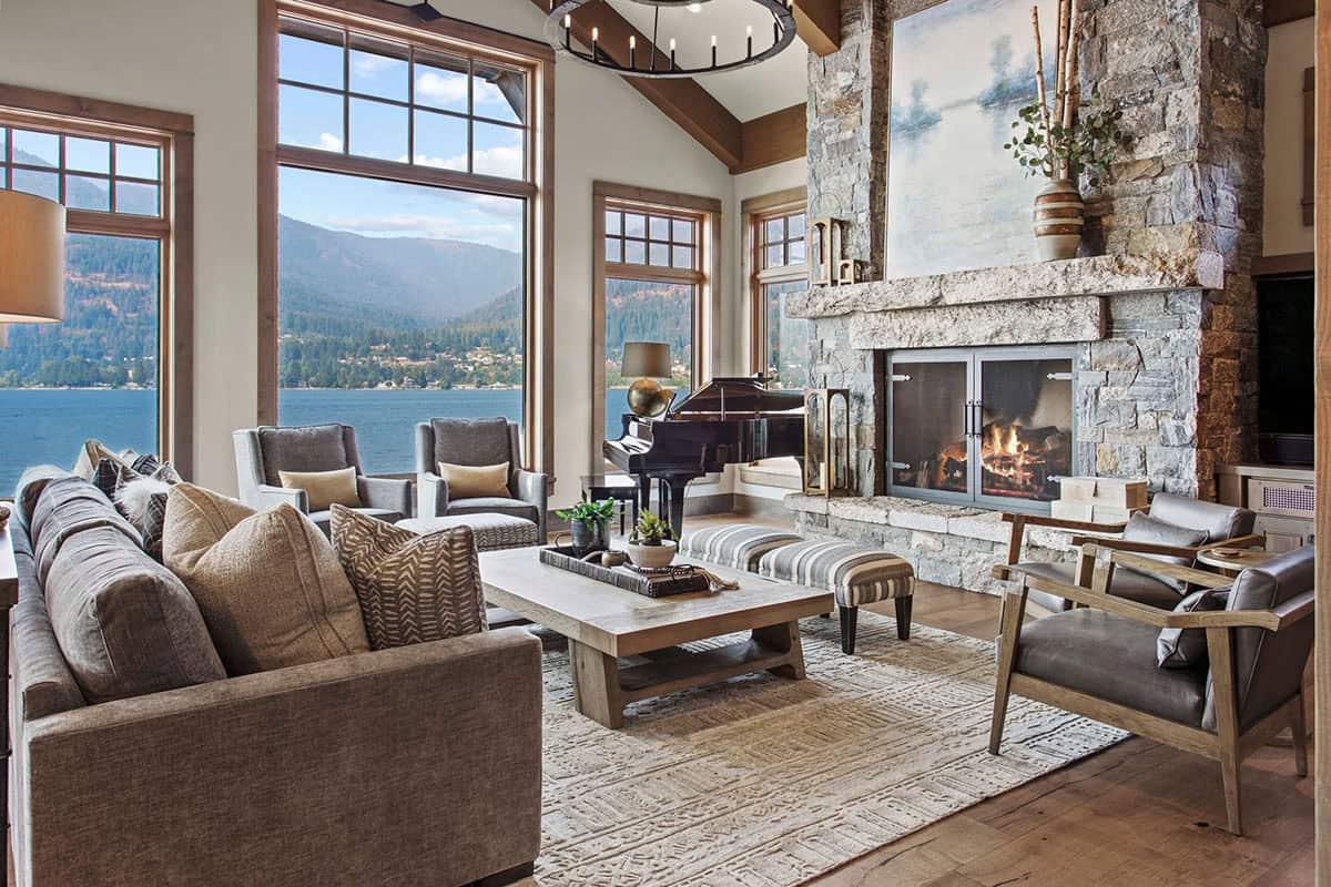 contemporary living room with a fireplace and lake view