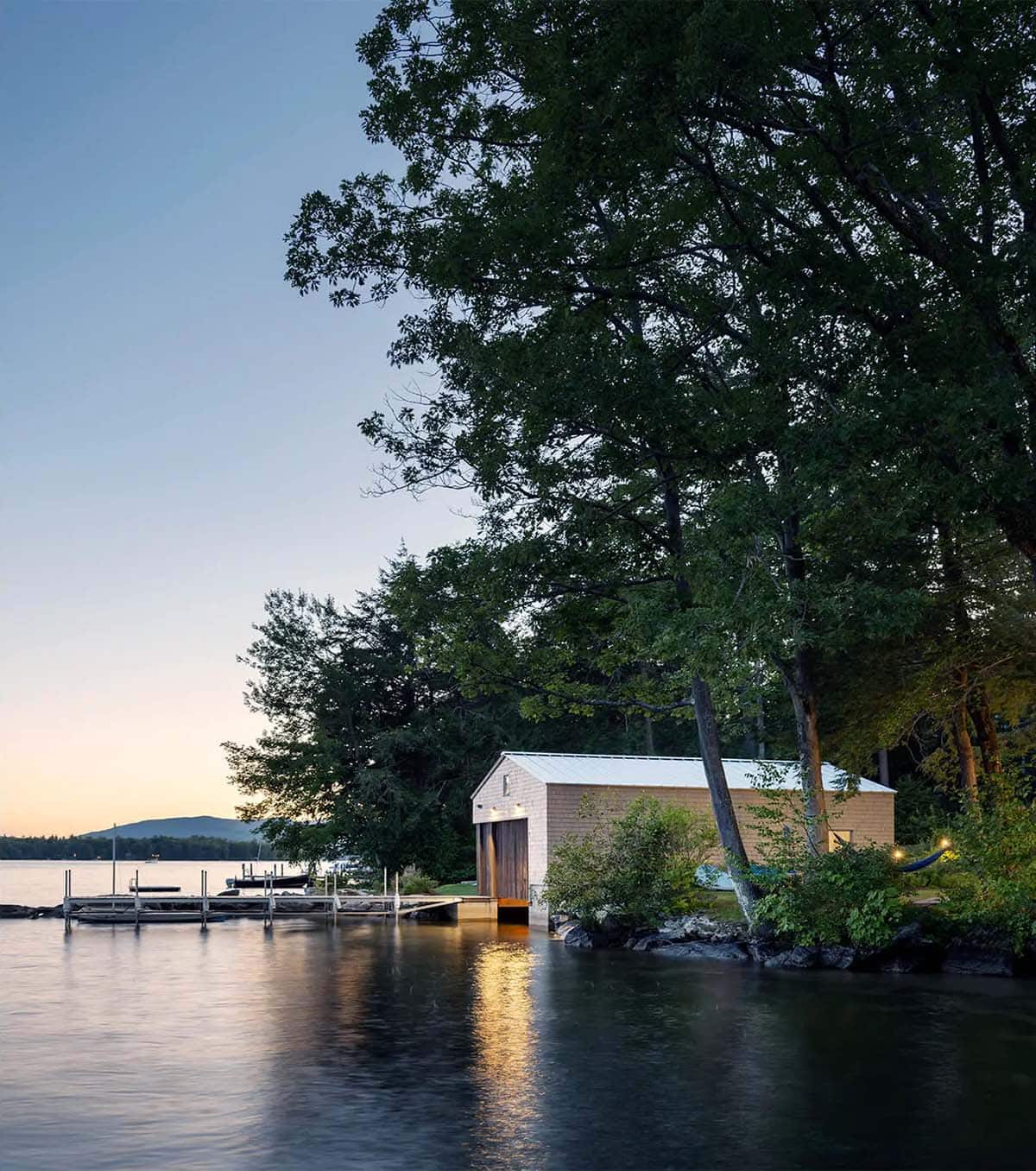 contemporary boat house exterior at dusk