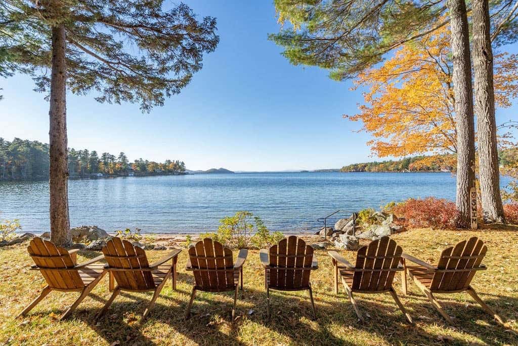 lake house exterior water view with adirondack chairs