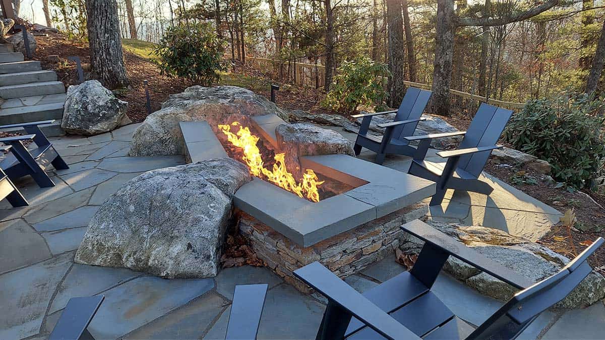 modern home exterior patio with a fire pit