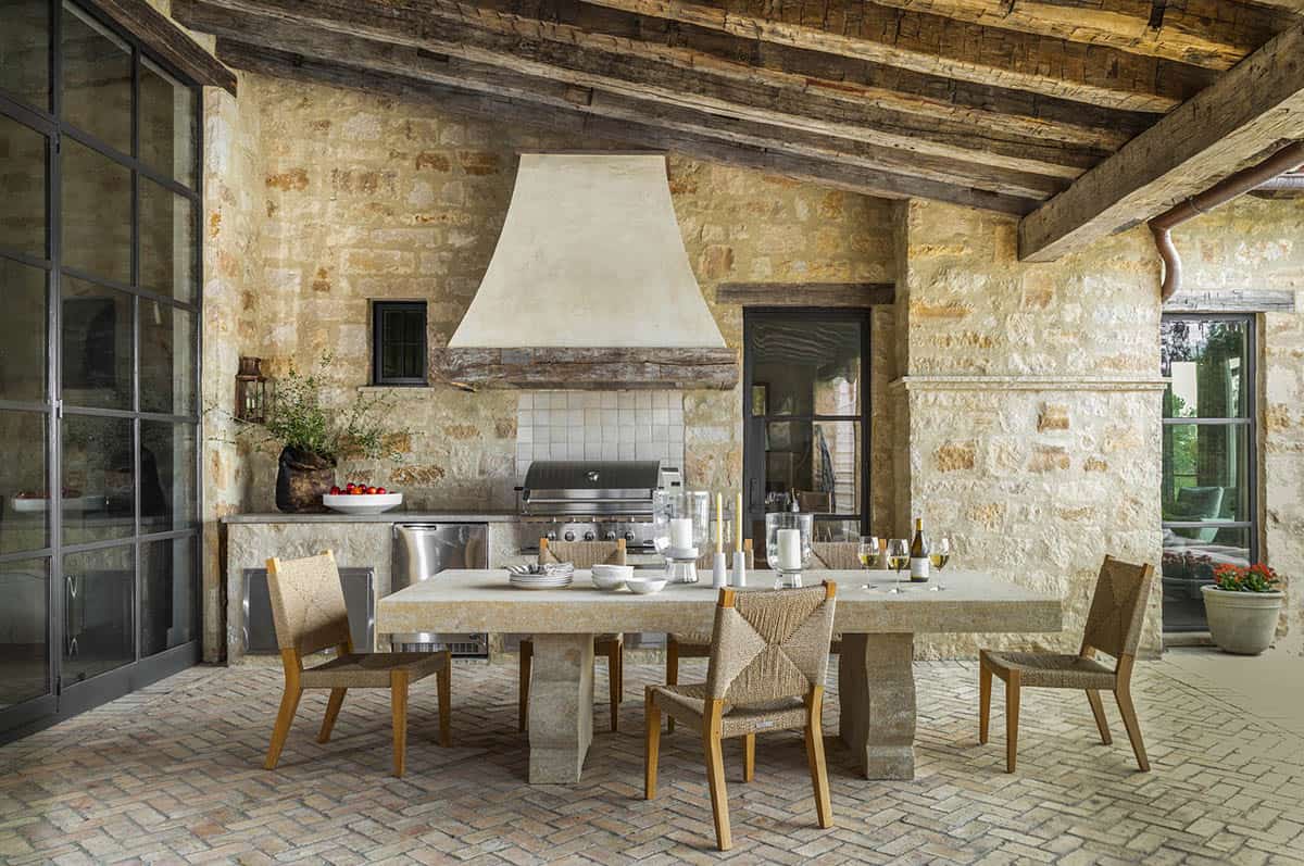 Mediterranean-style lake house exterior patio with an outdoor grill