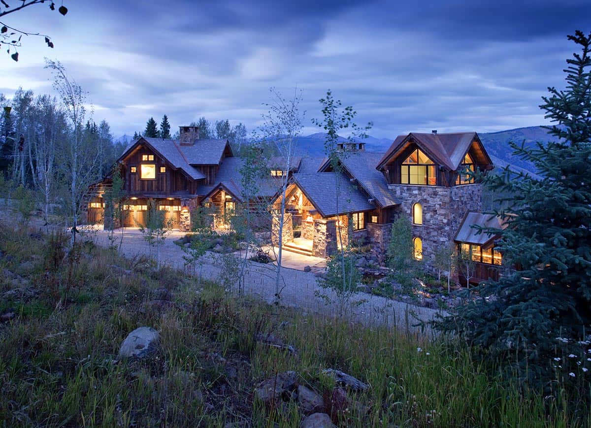 rustic mountain home exterior at dusk