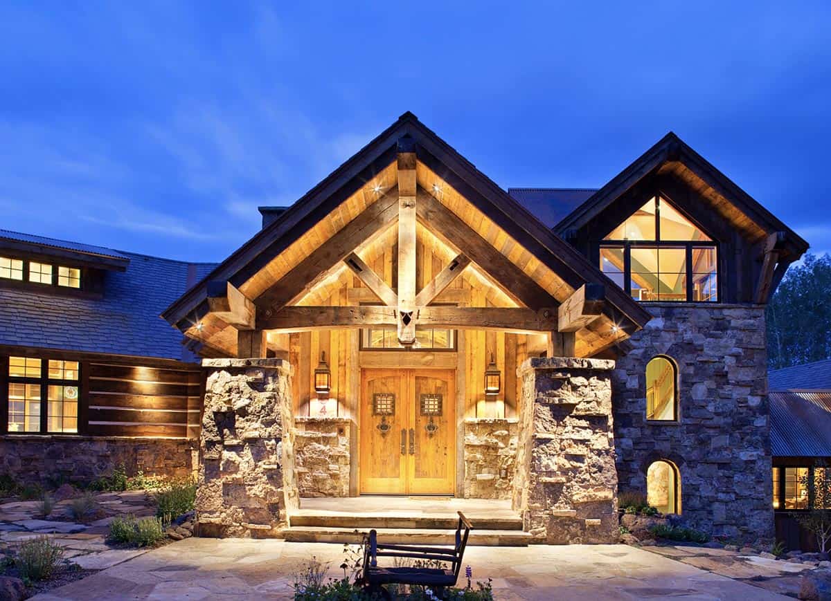 rustic mountain home exterior at dusk