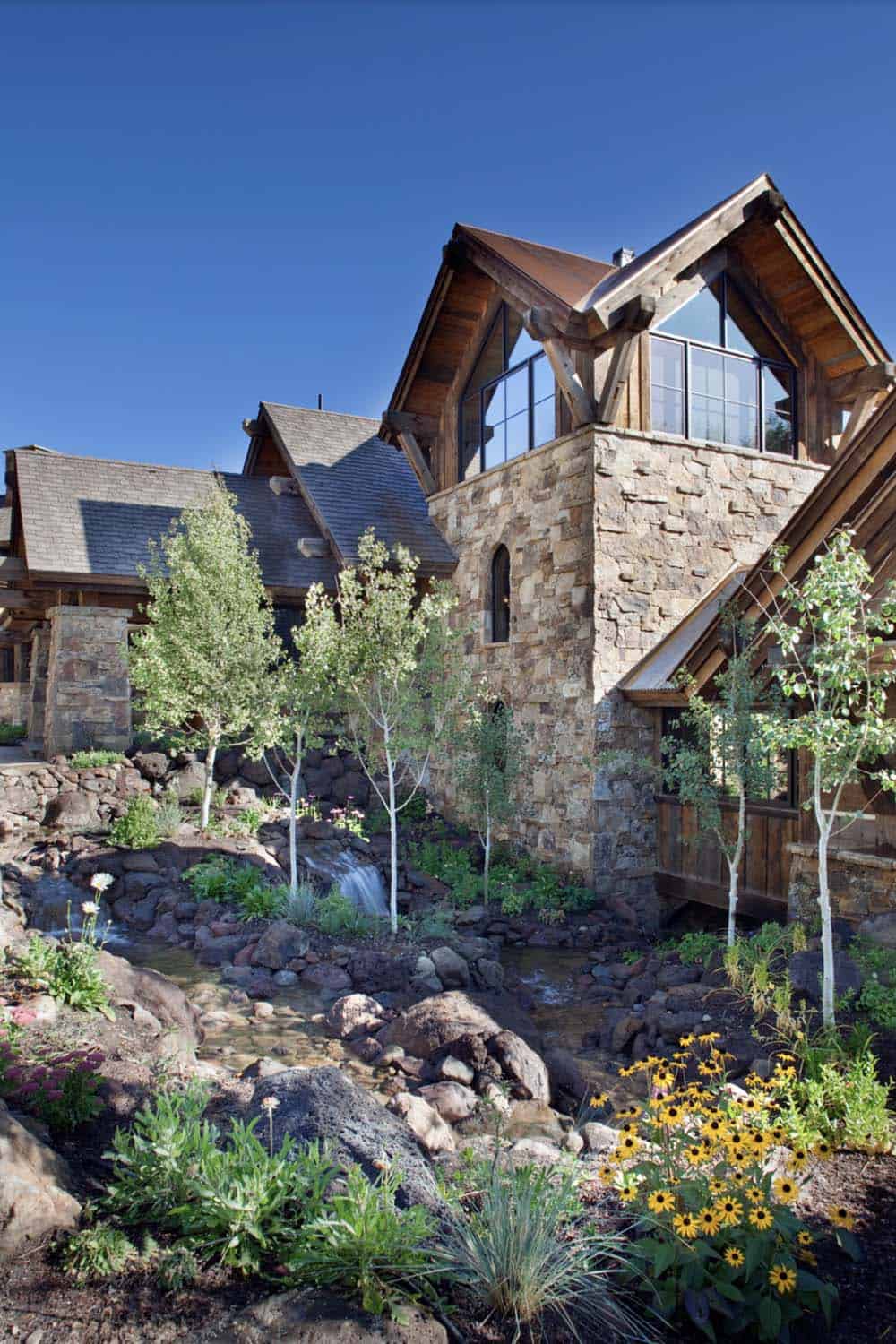 rustic mountain home exterior with a water feature