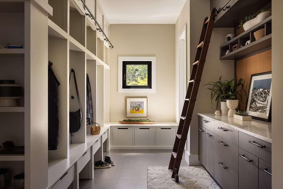 modern mudroom with a rolling ladder