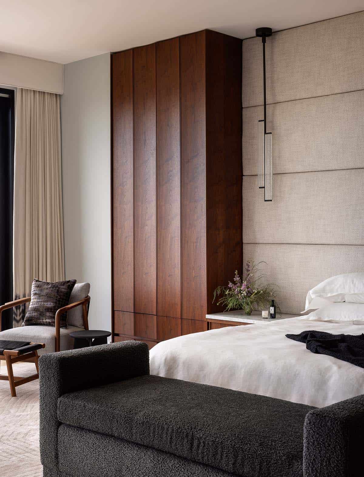 modern bedroom with a walnut and upholstered headboard wall