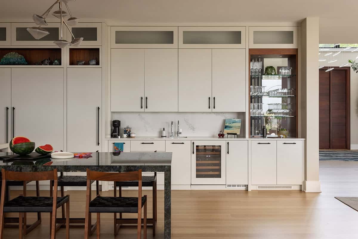 kitchen beverage station with custom cabinets and glass display