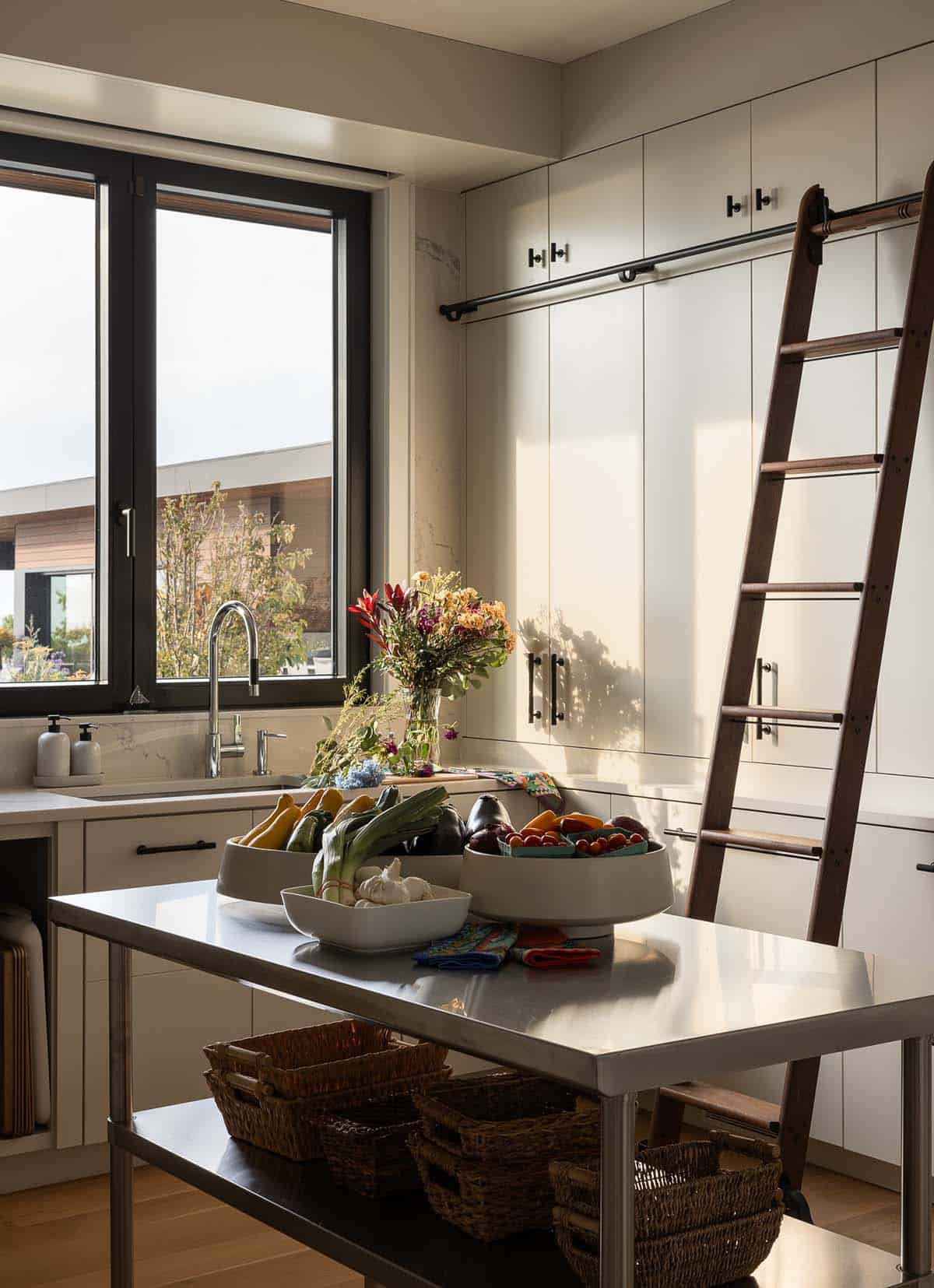 modern prep pantry with a rolling ladder and garden view
