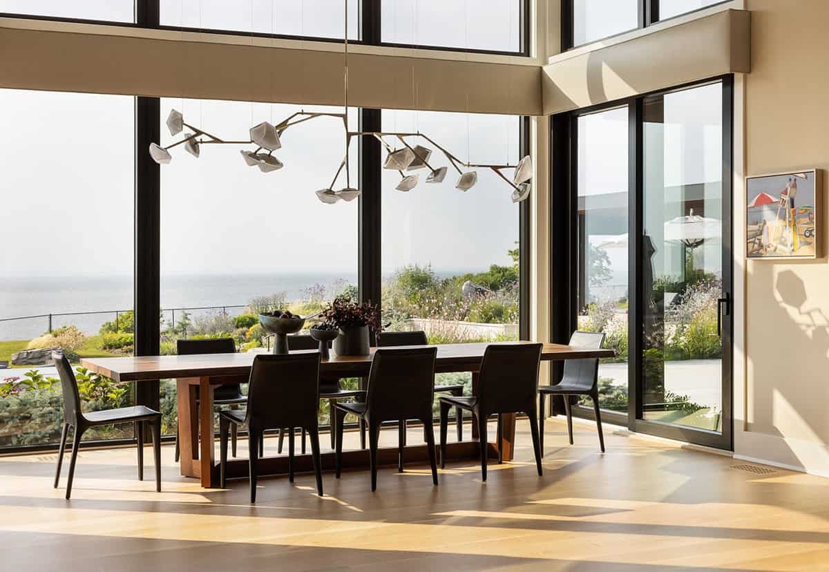 modern dining room with large windows, ocean view and sculptural lighting