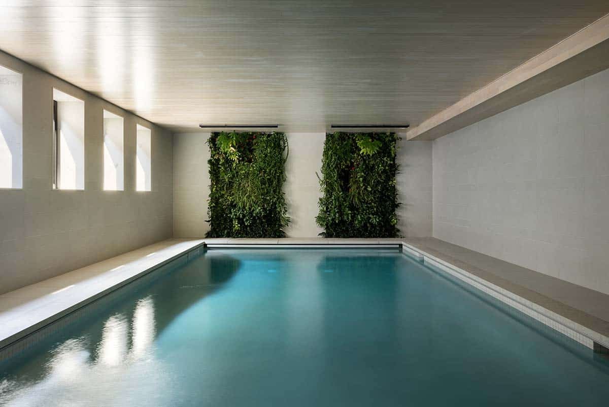 modern indoor pool with a biophilic living wall
