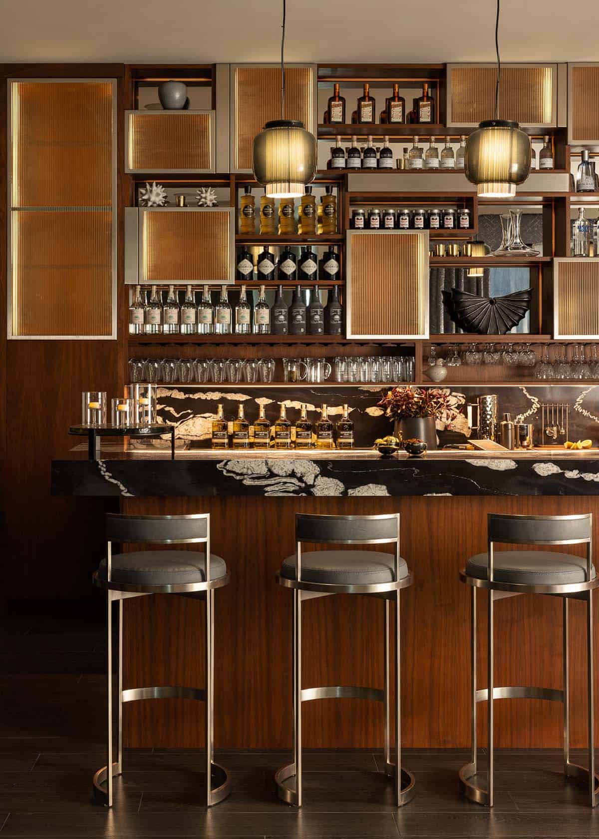 modern home bar with cococabana stone and walnut cabinets