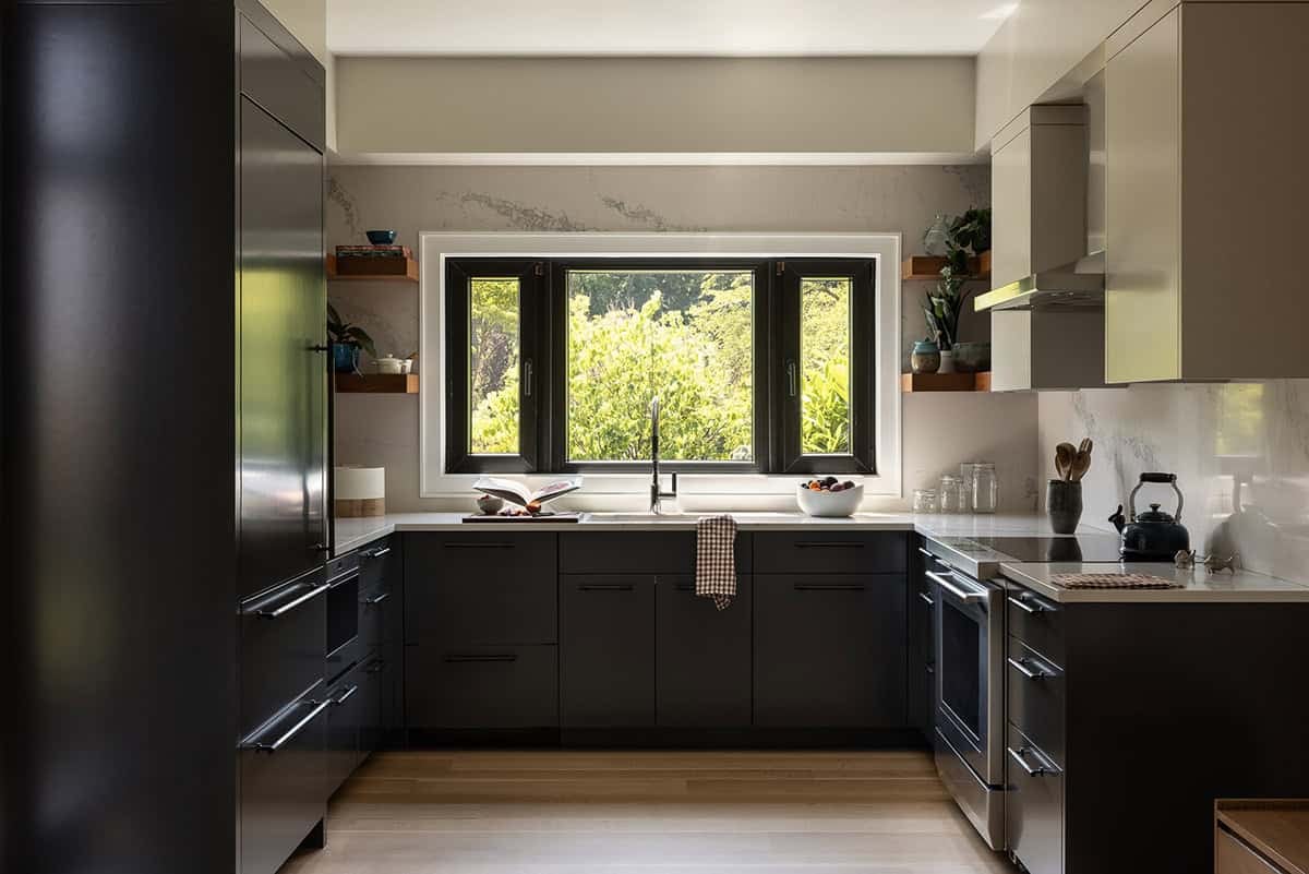 modern kitchen with black cabinetry garden view