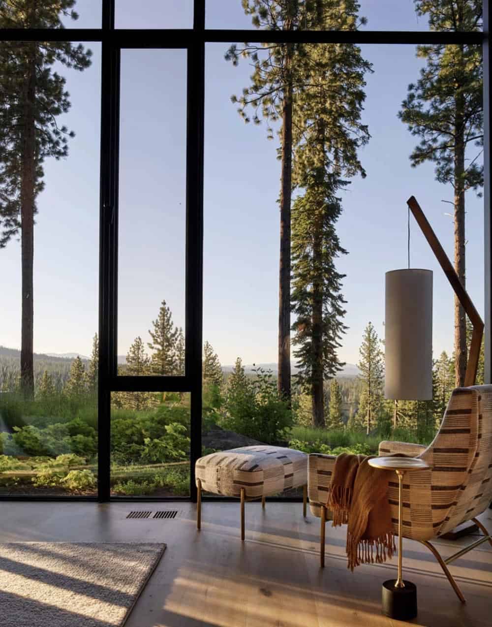 modern chair and ottoman with a large window view