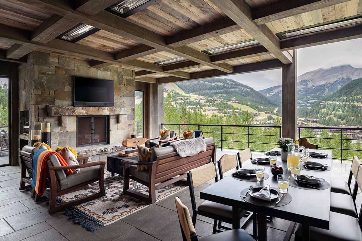 modern rustic covered patio with a fireplace and outdoor furniture