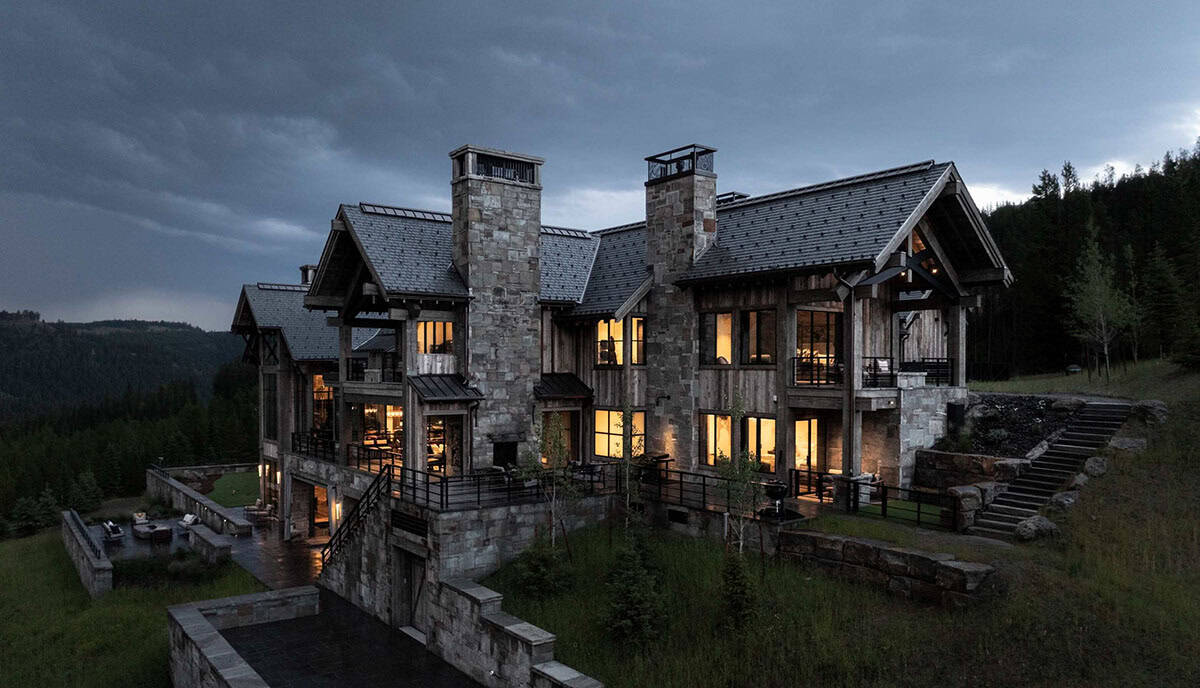 modern rustic home exterior backyard view at dusk