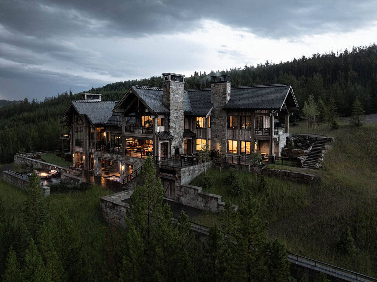 modern rustic home exterior backyard view at dusk