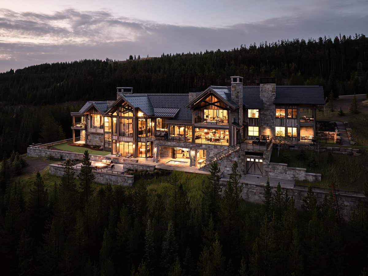 modern rustic home exterior backyard view at dusk