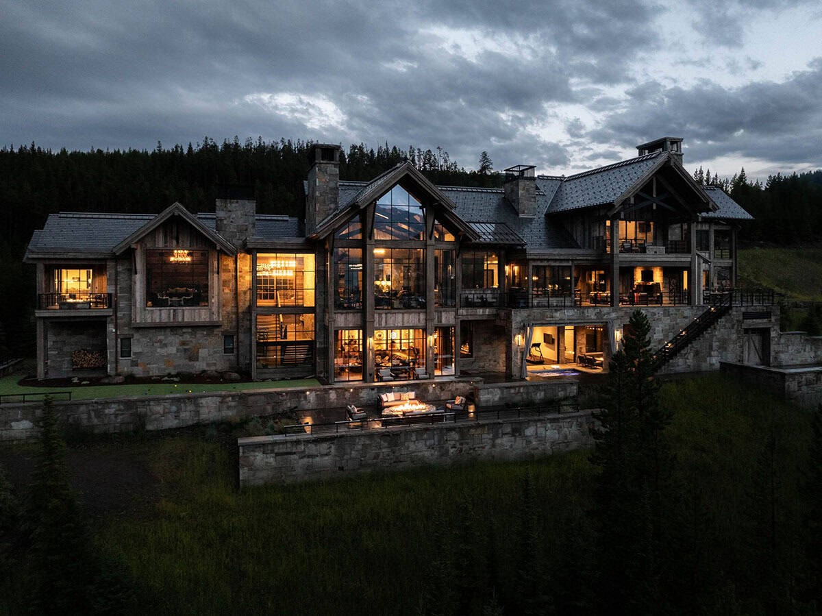 modern rustic home exterior backyard view at dusk