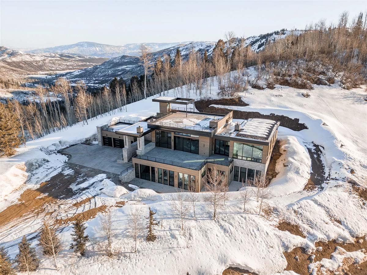 mountain modern home exterior with snow aerial view