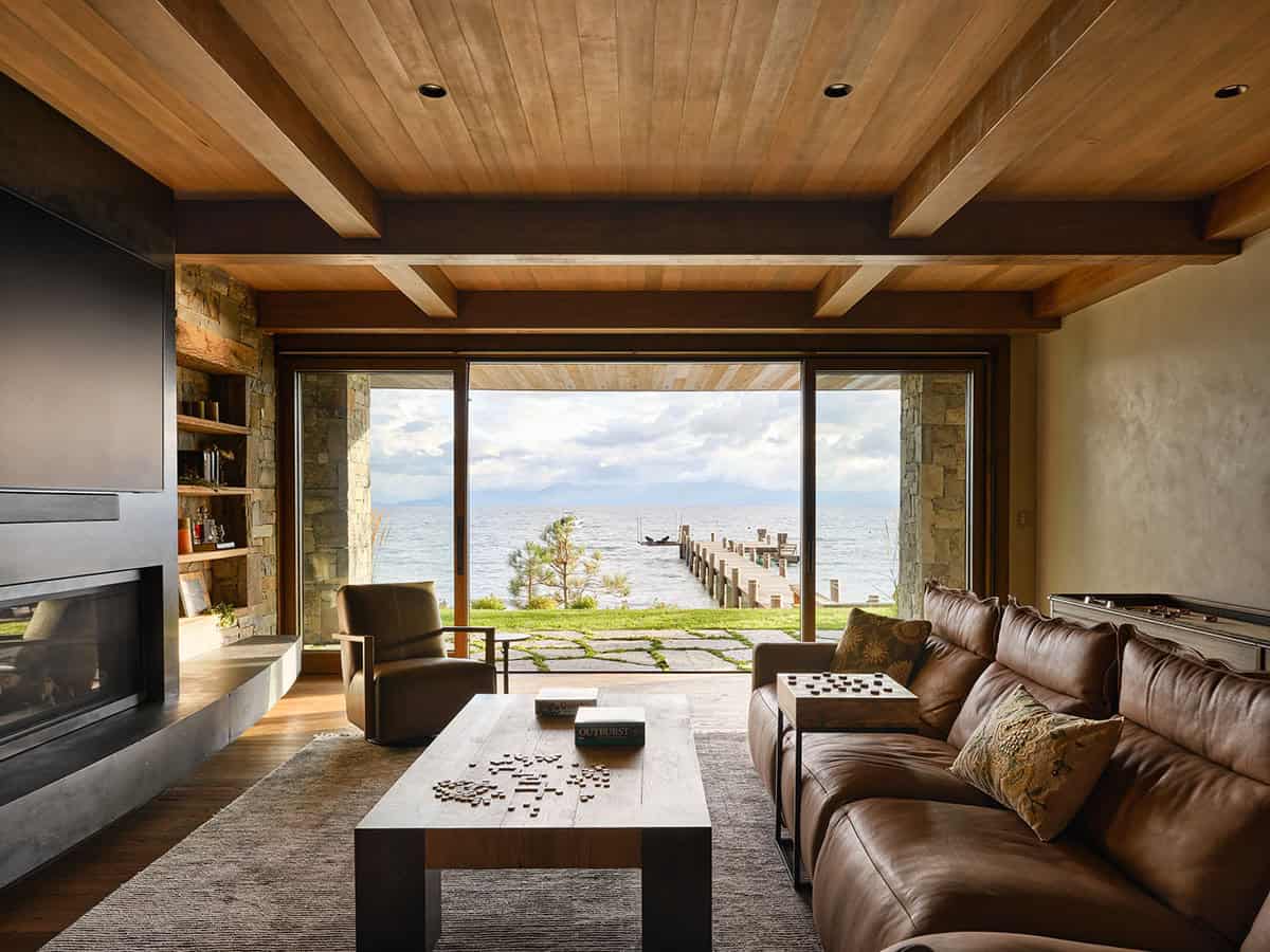 mountain modern family room with sliding glass doors and a lake view