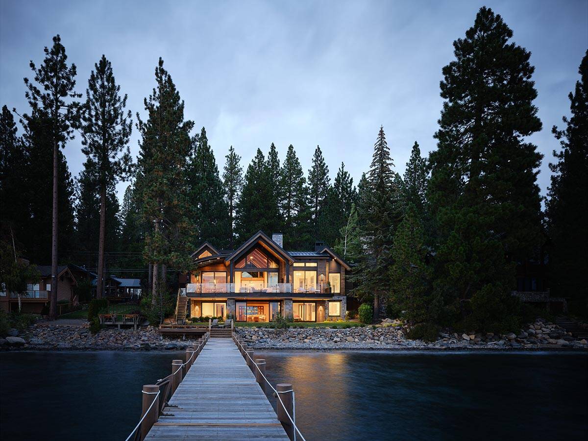 mountain modern lake house exterior with a dock at dusk
