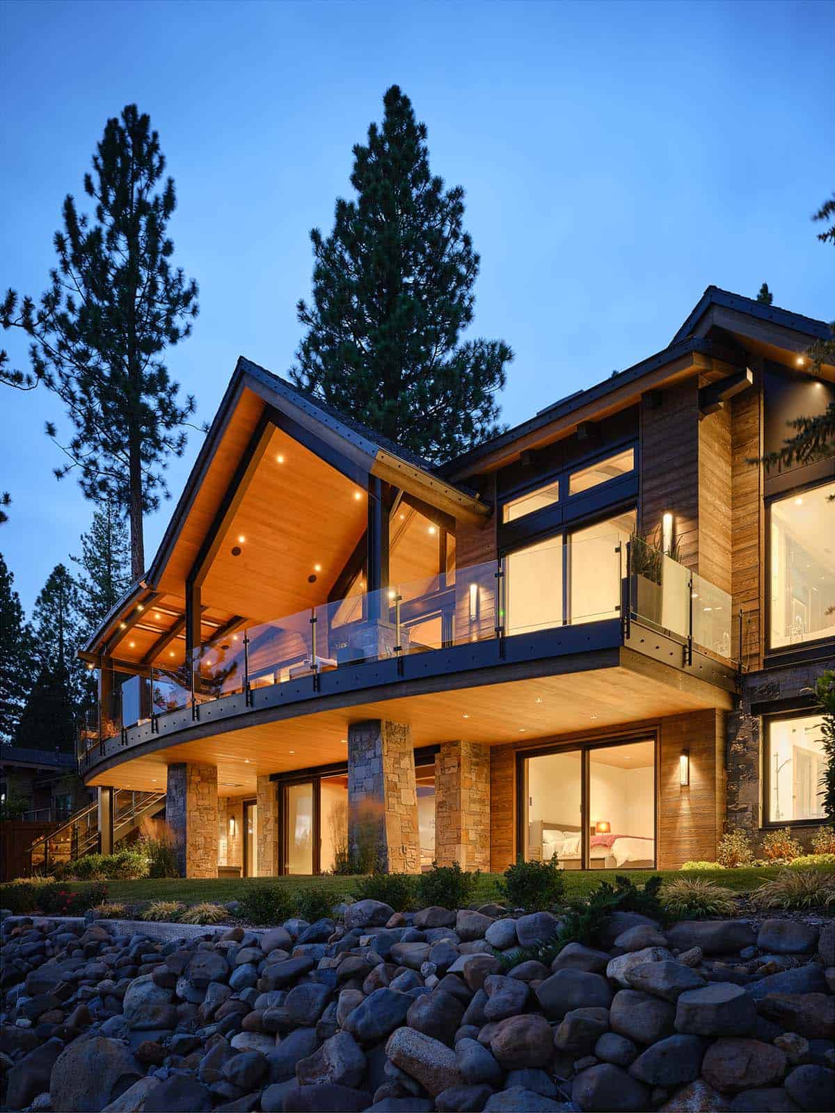 mountain modern lake house exterior backyard view at dusk