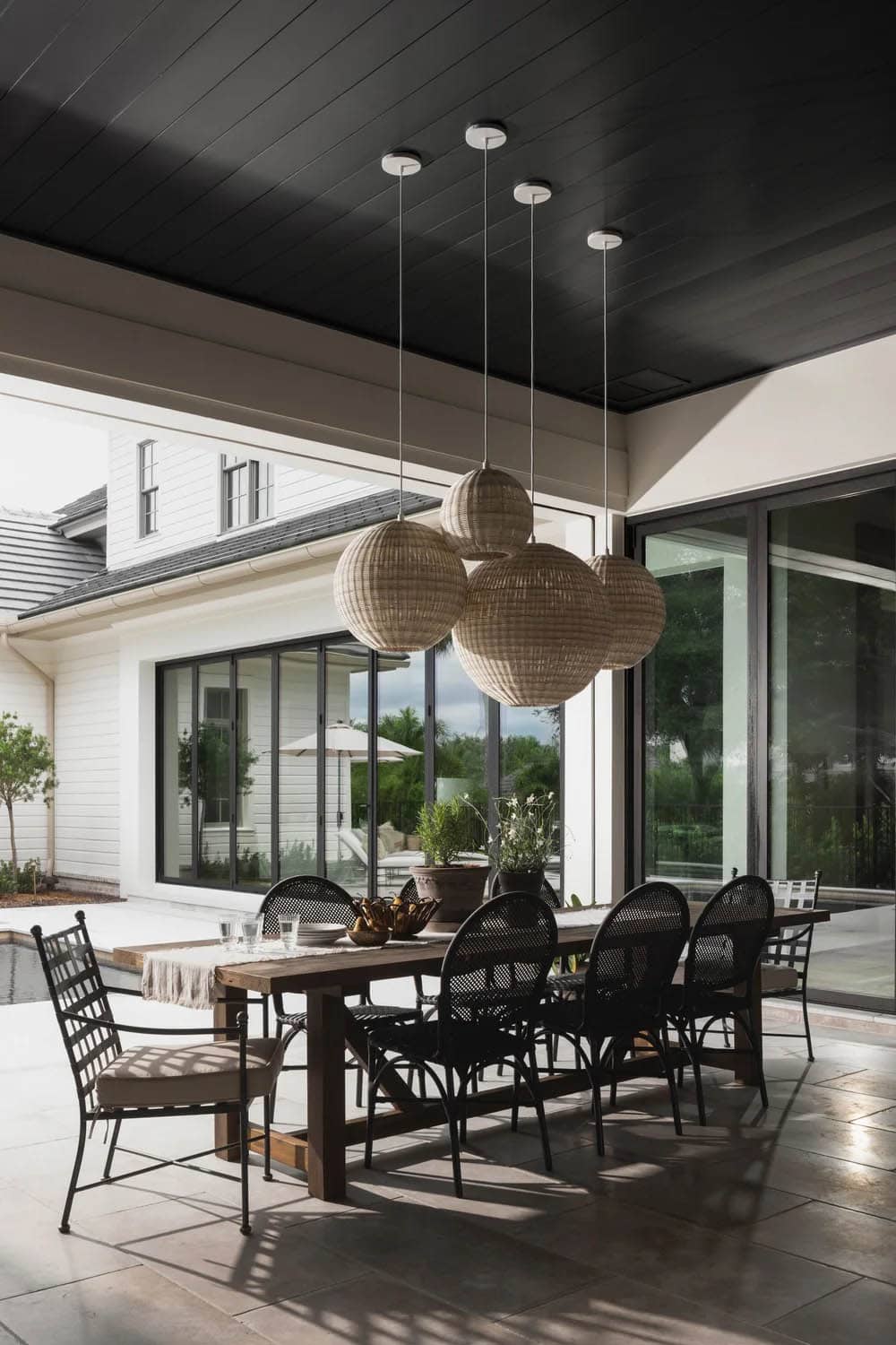 organic modern covered porch with a dining room