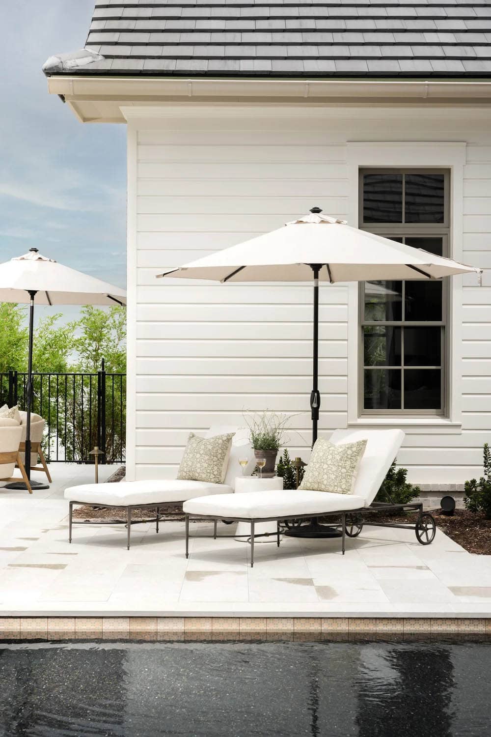 organic modern covered patio with lounge chairs and an umbrella